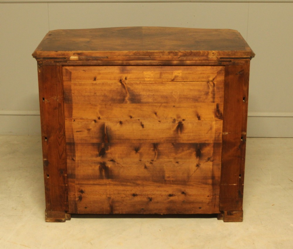 A Neo-Rococo Swedish chest of drawers featuring a serpentine front, highly figured burr walnut veneer, carved foliate corner pilasters, and four full-width drawers. View X