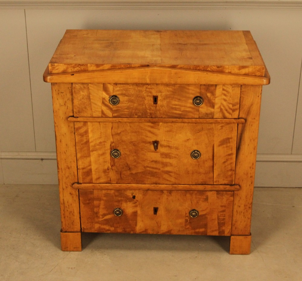 A 19th-century Swedish satin birch chest of drawers featuring three drawers with brass ring pull handles and a visible flame wood grain pattern. View II