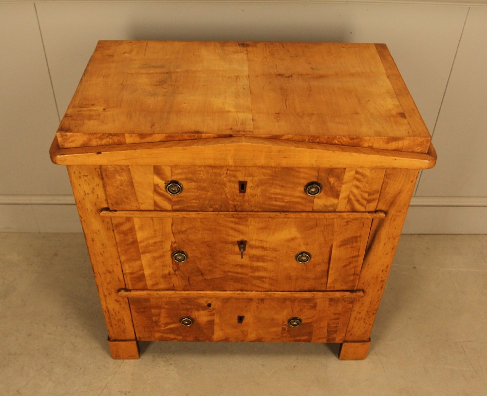 A 19th-century Swedish satin birch chest of drawers featuring three drawers with brass ring pull handles and a visible flame wood grain pattern. View III