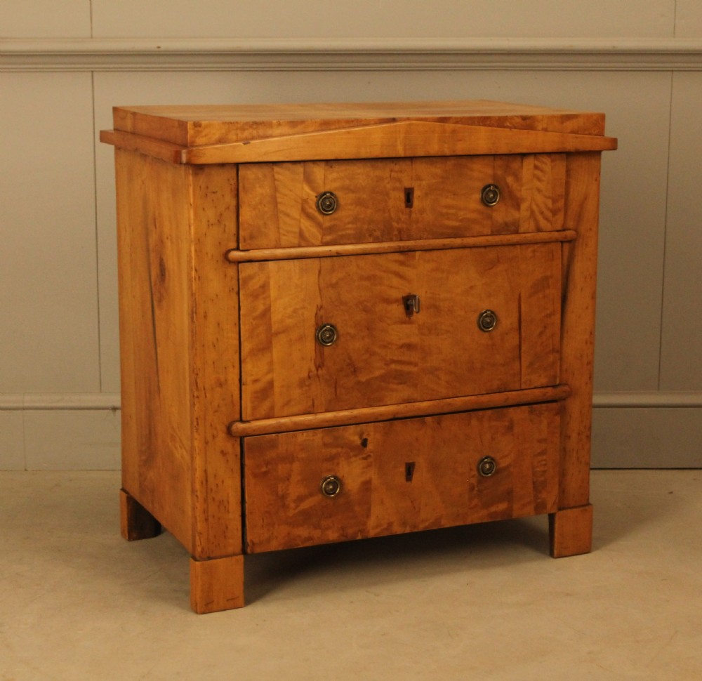 A 19th-century Swedish satin birch chest of drawers featuring three drawers with brass ring pull handles and a visible flame wood grain pattern. View IV