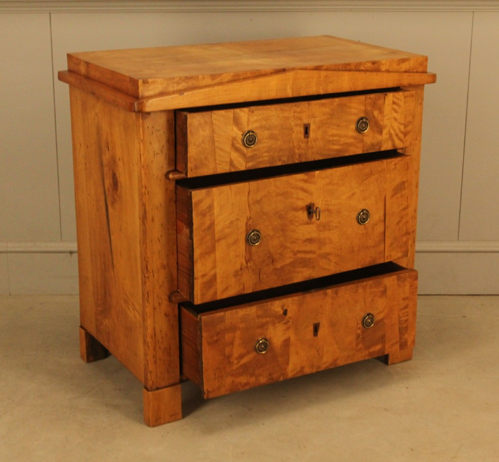 A 19th-century Swedish satin birch chest of drawers featuring three drawers with brass ring pull handles and a visible flame wood grain pattern. View VIII