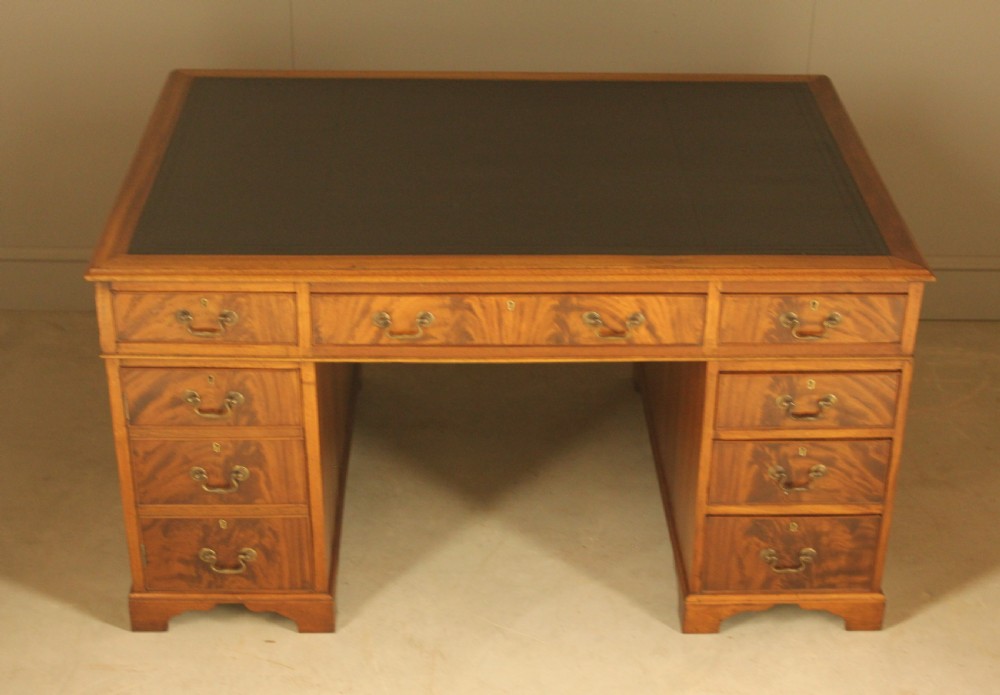A Victorian mahogany partners desk featuring a brown leather writing inset, twin pedestals with nine drawers, and brass swan-neck handles. View III