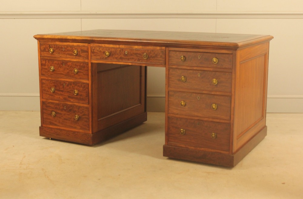 A 19th-century mahogany partners desk featuring a dark leather writing inset top, nine drawers on the front with brass ring handles, and twin pedestal bases. View IV