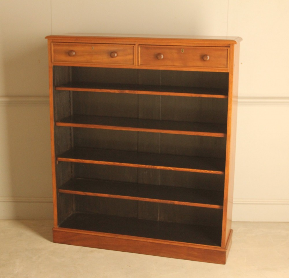 A tall 19th-century mahogany open bookcase featuring two upper frieze drawers with turned wooden knobs above five open shelves supported by a solid plinth base. View II