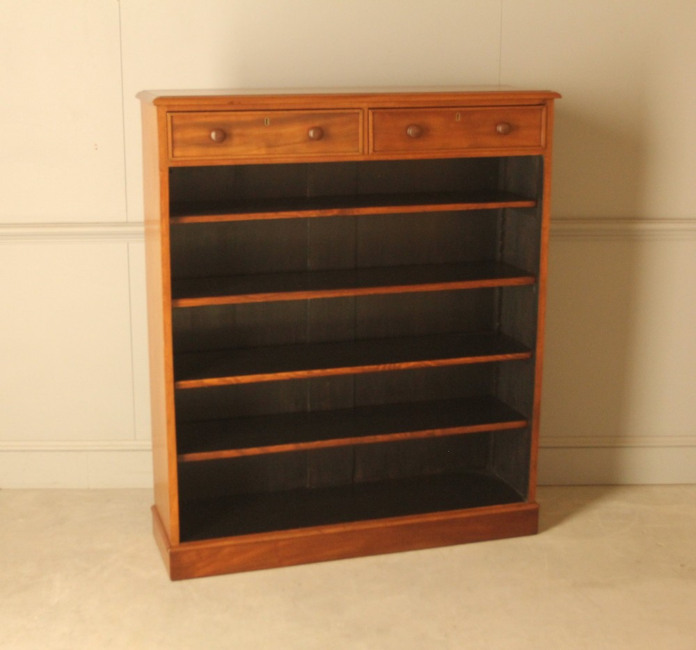 A tall 19th-century mahogany open bookcase featuring two upper frieze drawers with turned wooden knobs above five open shelves supported by a solid plinth base. View III