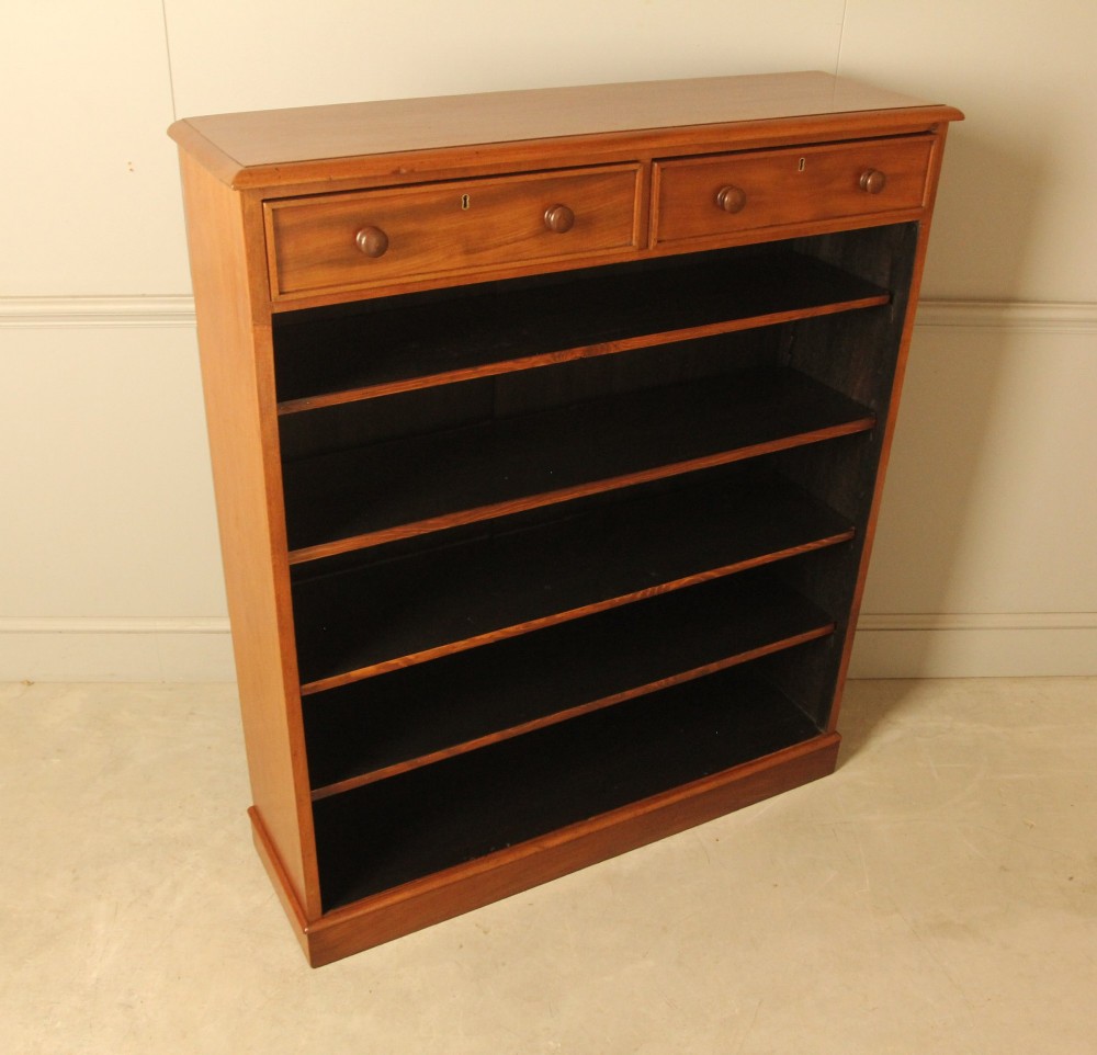 A tall 19th-century mahogany open bookcase featuring two upper frieze drawers with turned wooden knobs above five open shelves supported by a solid plinth base. View V