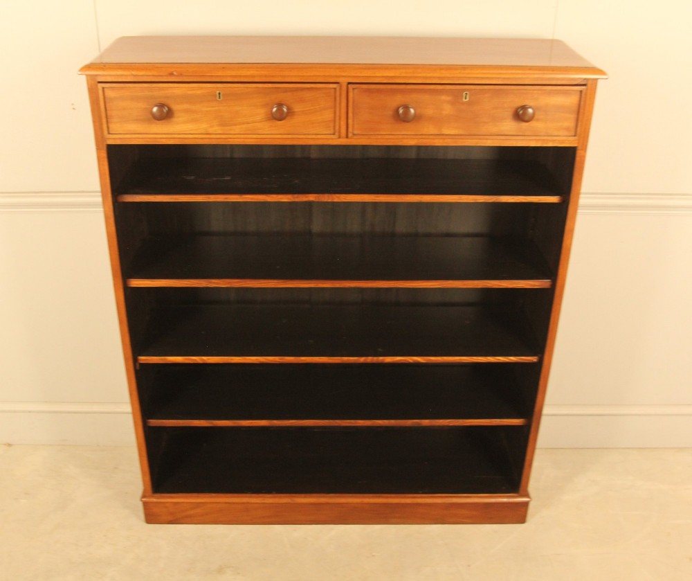 A tall 19th-century mahogany open bookcase featuring two upper frieze drawers with turned wooden knobs above five open shelves supported by a solid plinth base. View IX