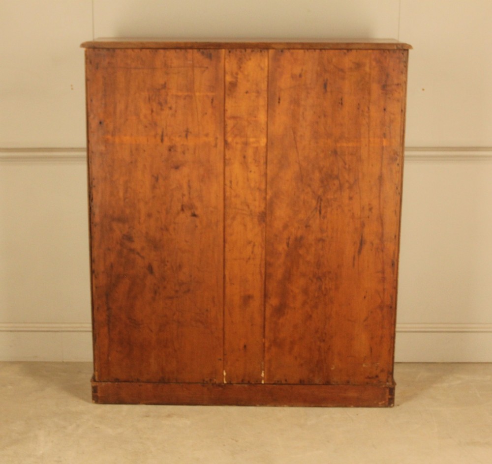 A tall 19th-century mahogany open bookcase featuring two upper frieze drawers with turned wooden knobs above five open shelves supported by a solid plinth base. View X