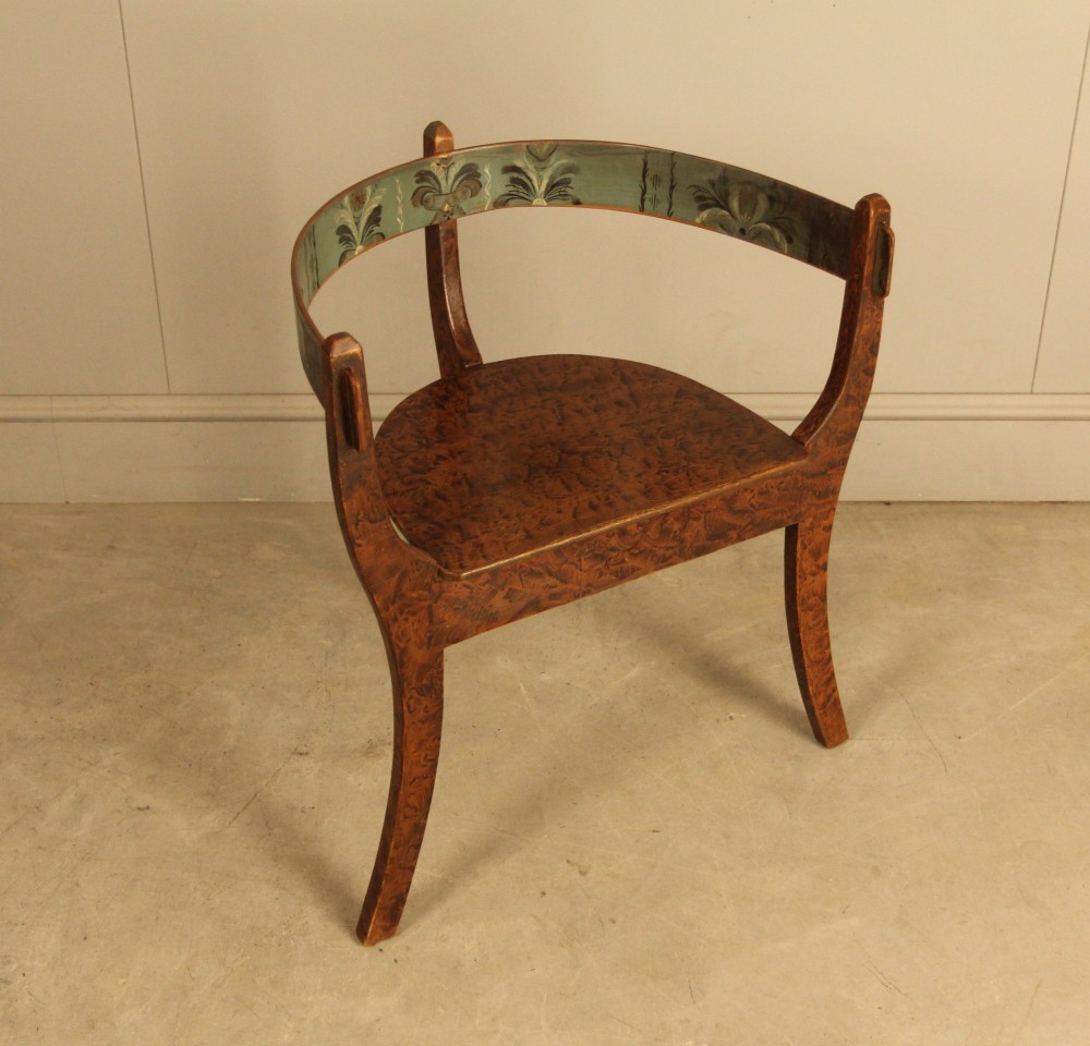 An early 20th-century Norwegian wooden chair with a curved backrest decorated with hand-painted green floral motifs and a faux-grained finish. View II
