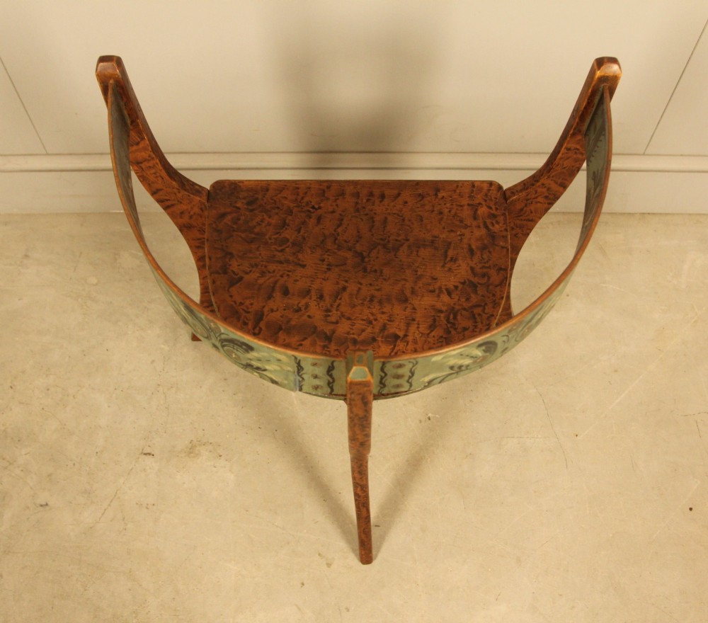 An early 20th-century Norwegian wooden chair with a curved backrest decorated with hand-painted green floral motifs and a faux-grained finish. View VI