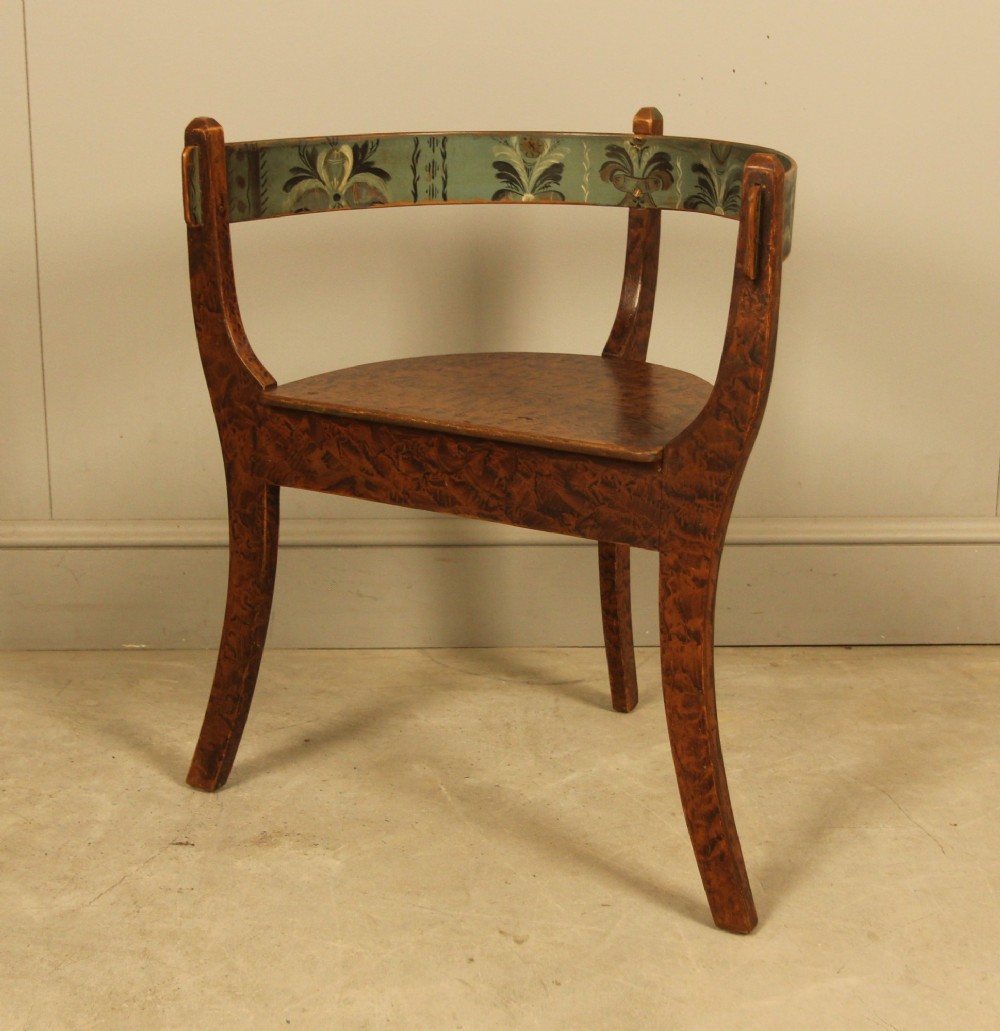 An early 20th-century Norwegian wooden chair with a curved backrest decorated with hand-painted green floral motifs and a faux-grained finish. View VIII