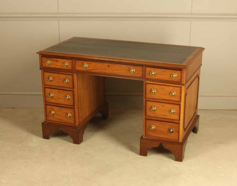 Victorian mahogany pedestal writing desk featuring nine drawers with brass ring pulls and bracket feet. View VII