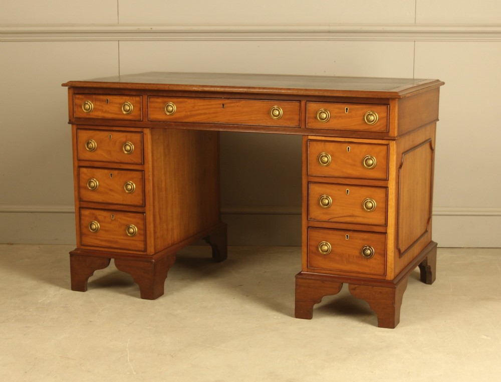 Victorian mahogany pedestal writing desk featuring nine drawers with brass ring pulls and bracket feet. View VIII