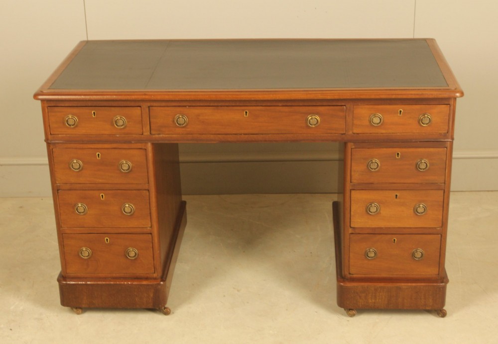 A Victorian mahogany pedestal desk featuring nine drawers with brass ring pulls and an inset leather writing top. View III