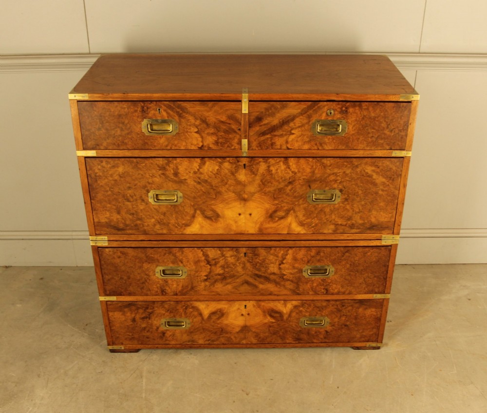 A Victorian burr walnut campaign chest of drawers featuring flush brass corner mounts, recessed drawer pulls, and side carrying handles. View IV
