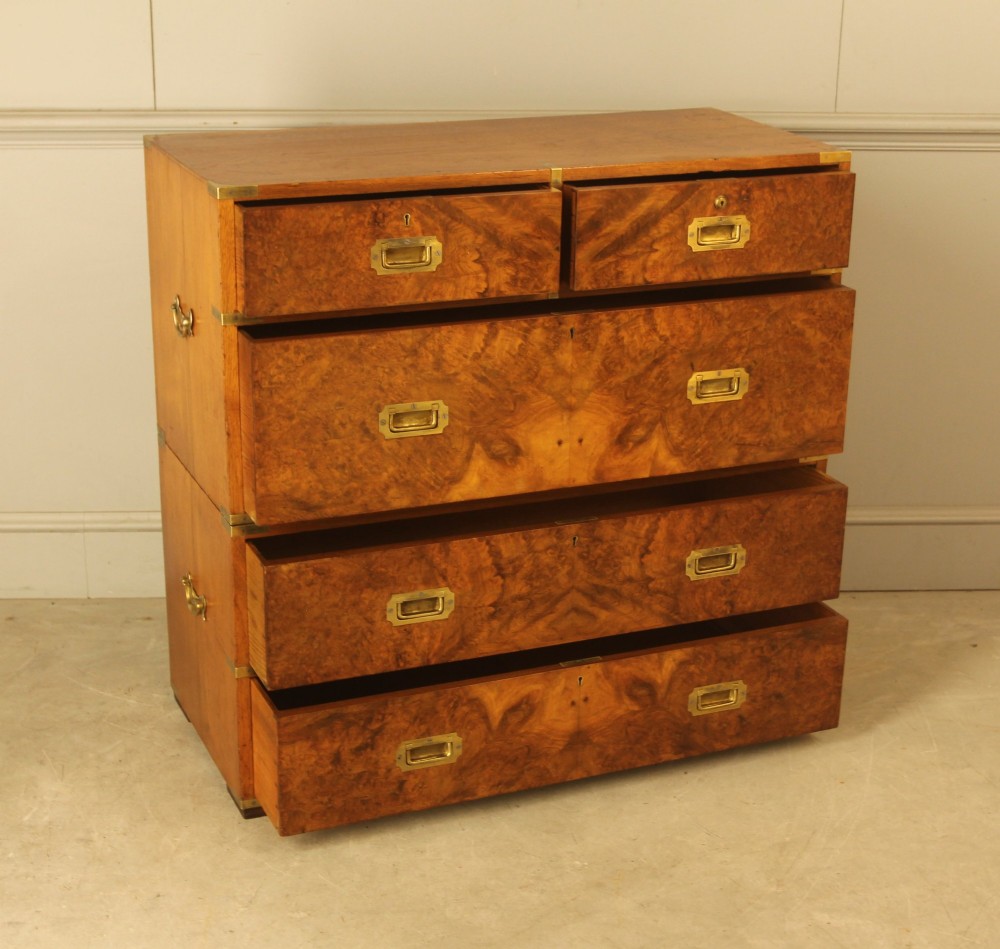 A Victorian burr walnut campaign chest of drawers featuring flush brass corner mounts, recessed drawer pulls, and side carrying handles. View VII