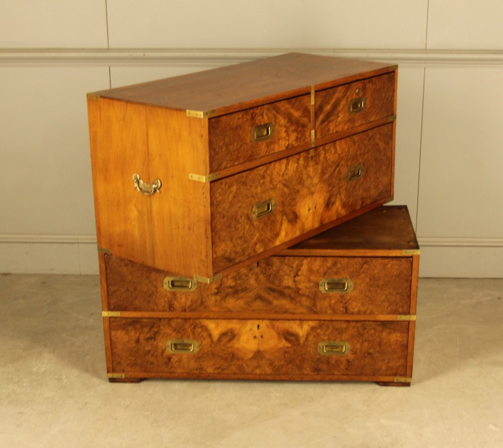 A Victorian burr walnut campaign chest of drawers featuring flush brass corner mounts, recessed drawer pulls, and side carrying handles. View IX