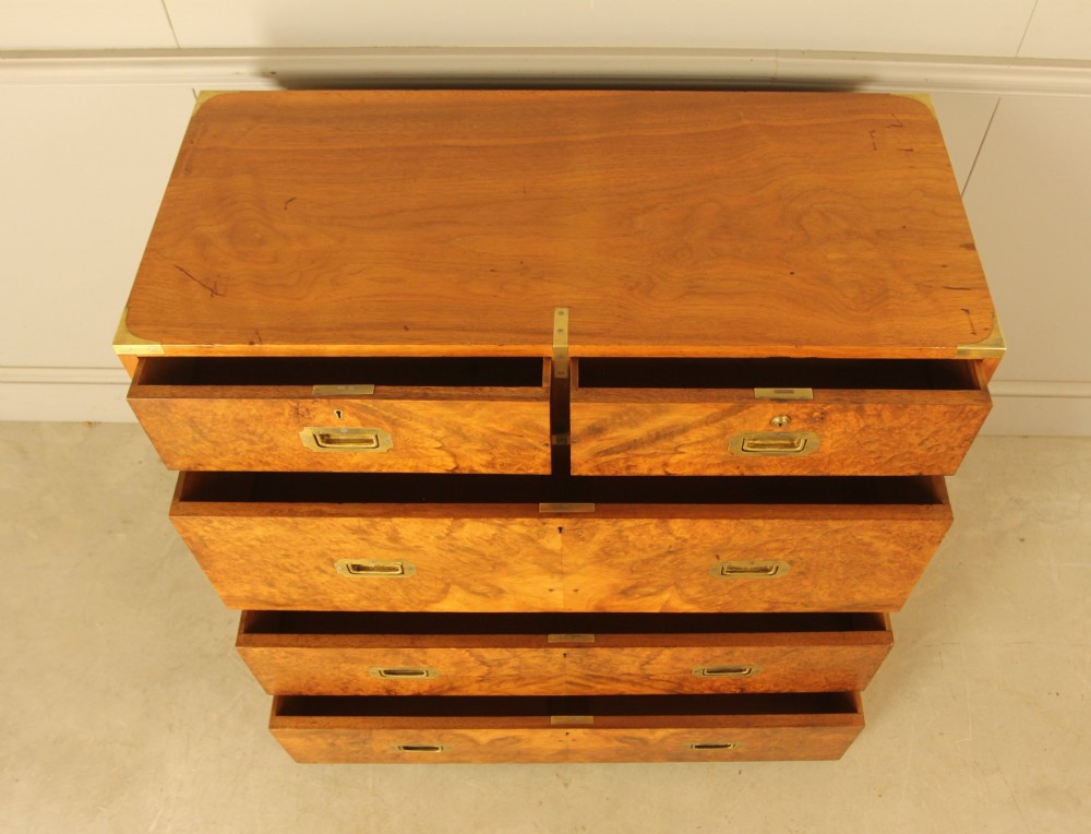 A Victorian burr walnut campaign chest of drawers featuring flush brass corner mounts, recessed drawer pulls, and side carrying handles. View X