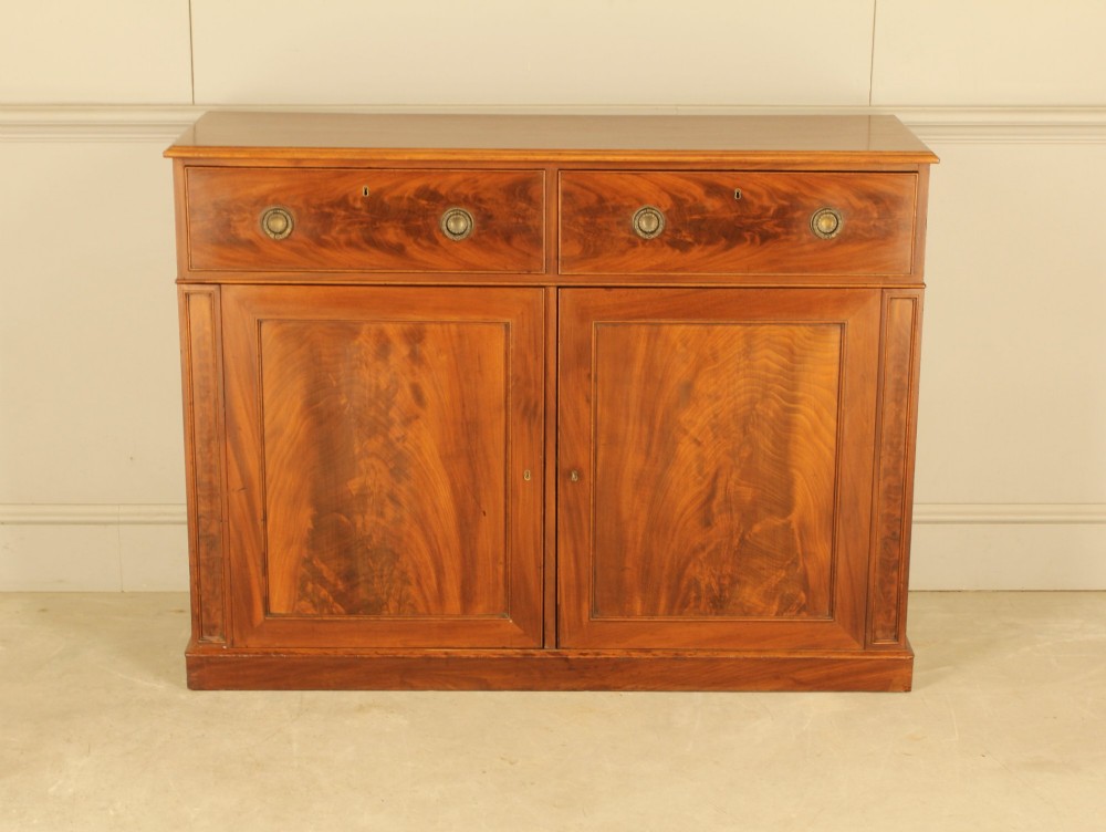 A 1910 curl‑mahogany two door sideboard