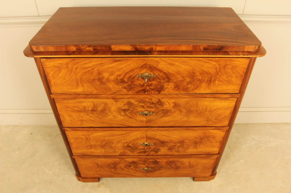 A 19th-century Swedish chest of drawers in warm curl mahogany featuring book-matched veneer, brass escutcheons, and a clean rectangular silhouette. View III