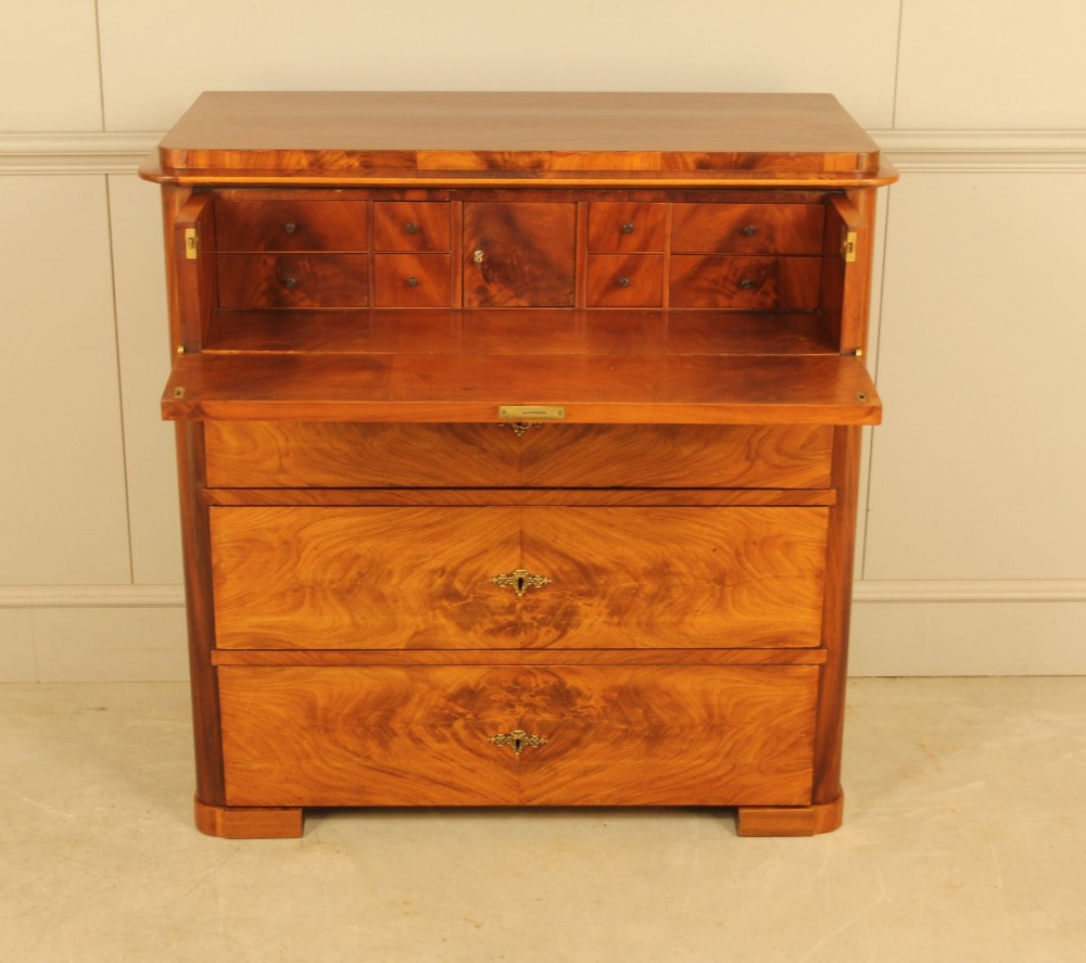 A 19th-century Swedish chest of drawers in warm curl mahogany featuring book-matched veneer, brass escutcheons, and a clean rectangular silhouette. View IV