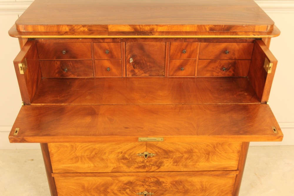 A 19th-century Swedish chest of drawers in warm curl mahogany featuring book-matched veneer, brass escutcheons, and a clean rectangular silhouette. View V