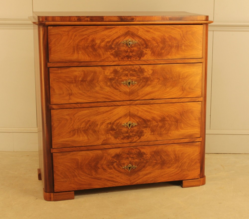 A 19th-century Swedish chest of drawers in warm curl mahogany featuring book-matched veneer, brass escutcheons, and a clean rectangular silhouette. View VIII