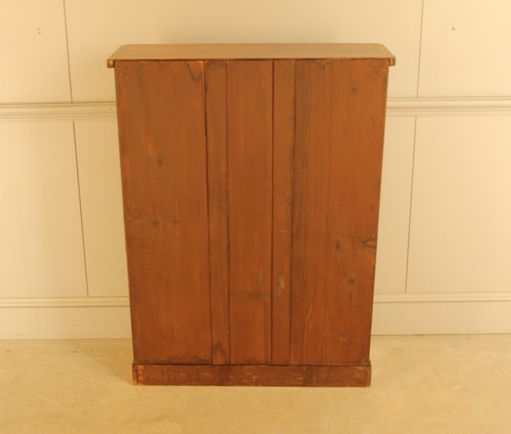 A Victorian walnut open bookcase featuring four horizontal shelves, carved decorative corbels at the upper corners, and a dark painted backboard. View X