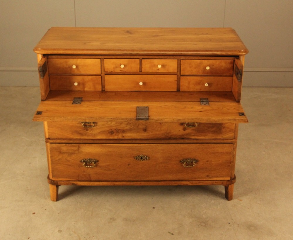 A 19th-century Swedish oak secretaire chest featuring an open hinged fall-front writing flap revealing fitted interior drawers, positioned above two large lower drawers. View IV