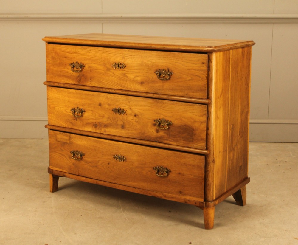 A 19th-century Swedish oak secretaire chest featuring an open hinged fall-front writing flap revealing fitted interior drawers, positioned above two large lower drawers. View VI