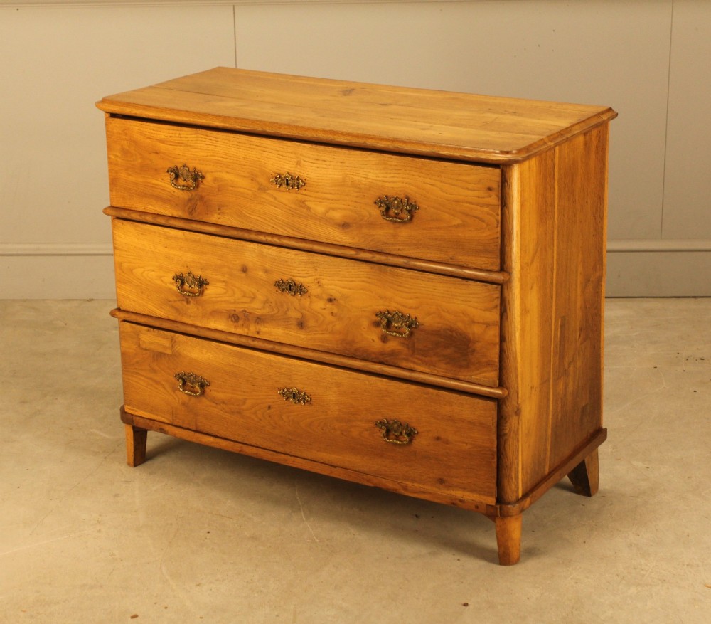 A 19th-century Swedish oak secretaire chest featuring an open hinged fall-front writing flap revealing fitted interior drawers, positioned above two large lower drawers. View VIII