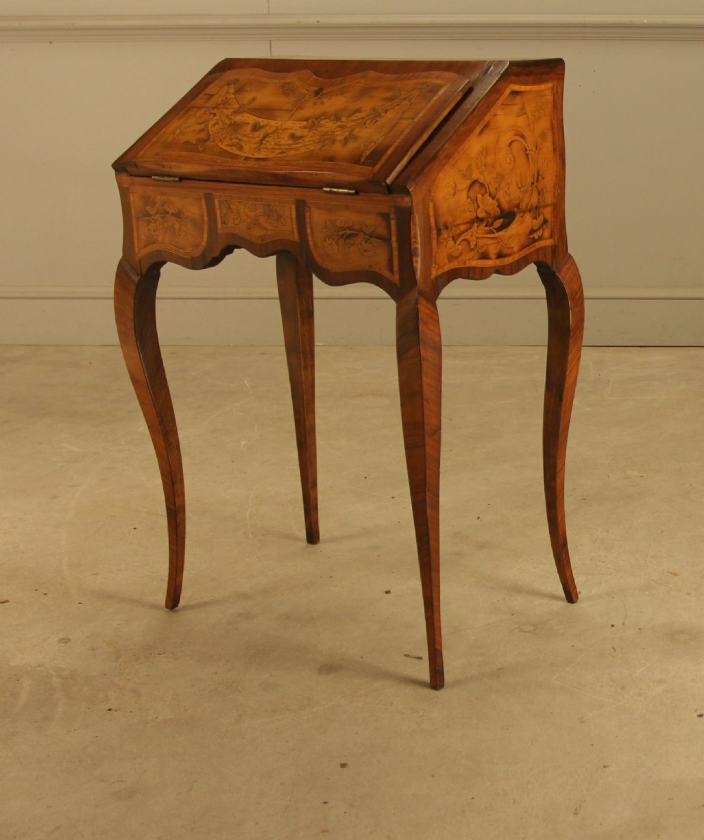 A 19th-century Italian walnut writing bureau featuring floral marquetry inlay, a slanted fall front, and slender cabriole legs. View III