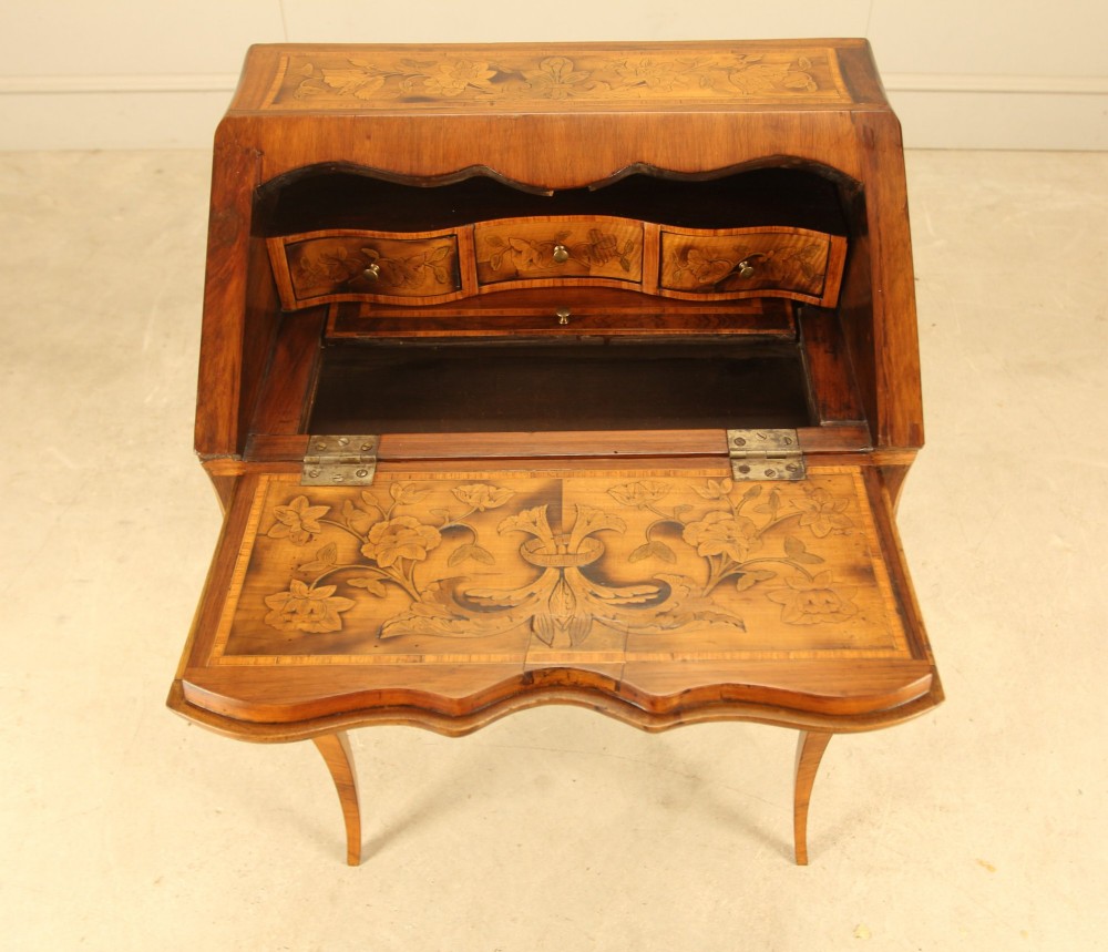 A 19th-century Italian walnut writing bureau featuring floral marquetry inlay, a slanted fall front, and slender cabriole legs. View VIII