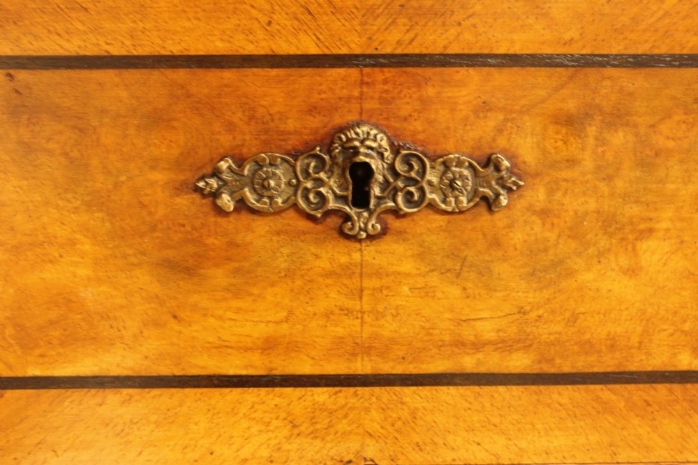 A tall 19th-century Swedish burr walnut chest of drawers featuring seven drawers, crossbanded inlay, ornate brass handles, and a stepped top section. View VIII