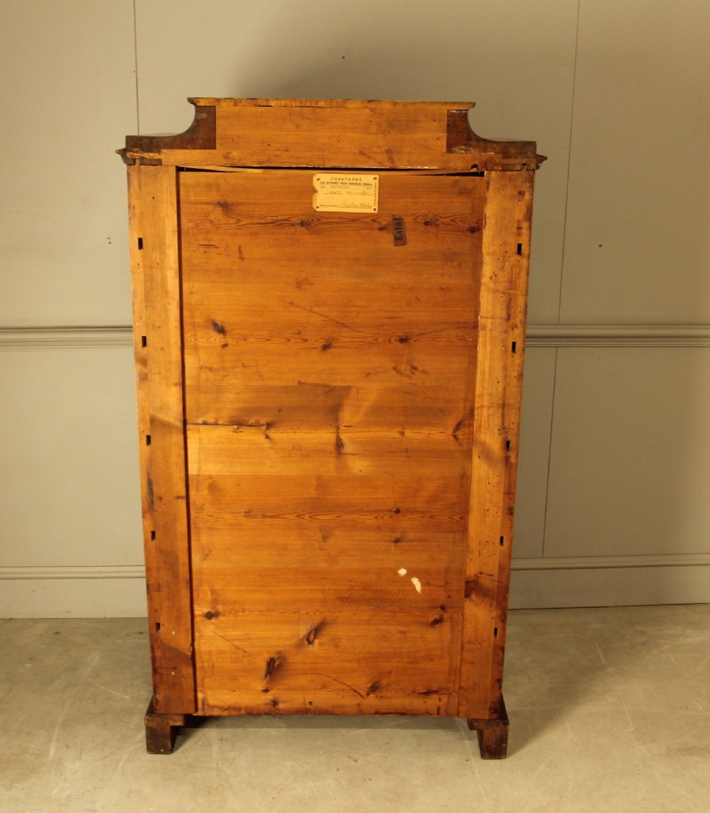 A tall 19th-century Swedish burr walnut chest of drawers featuring seven drawers, crossbanded inlay, ornate brass handles, and a stepped top section. View XI