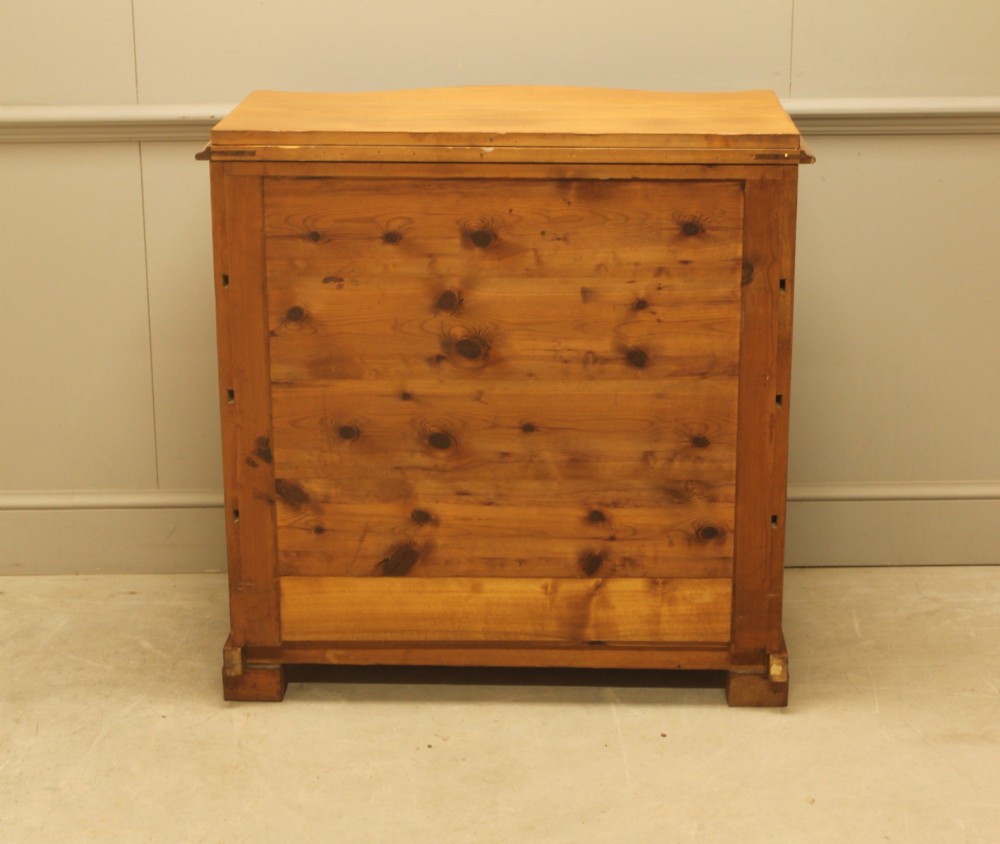 A 19th-century Swedish burr walnut chest of drawers featuring a serpentine front, four graduated drawers, brass escutcheons, and carved side pilasters. View XI