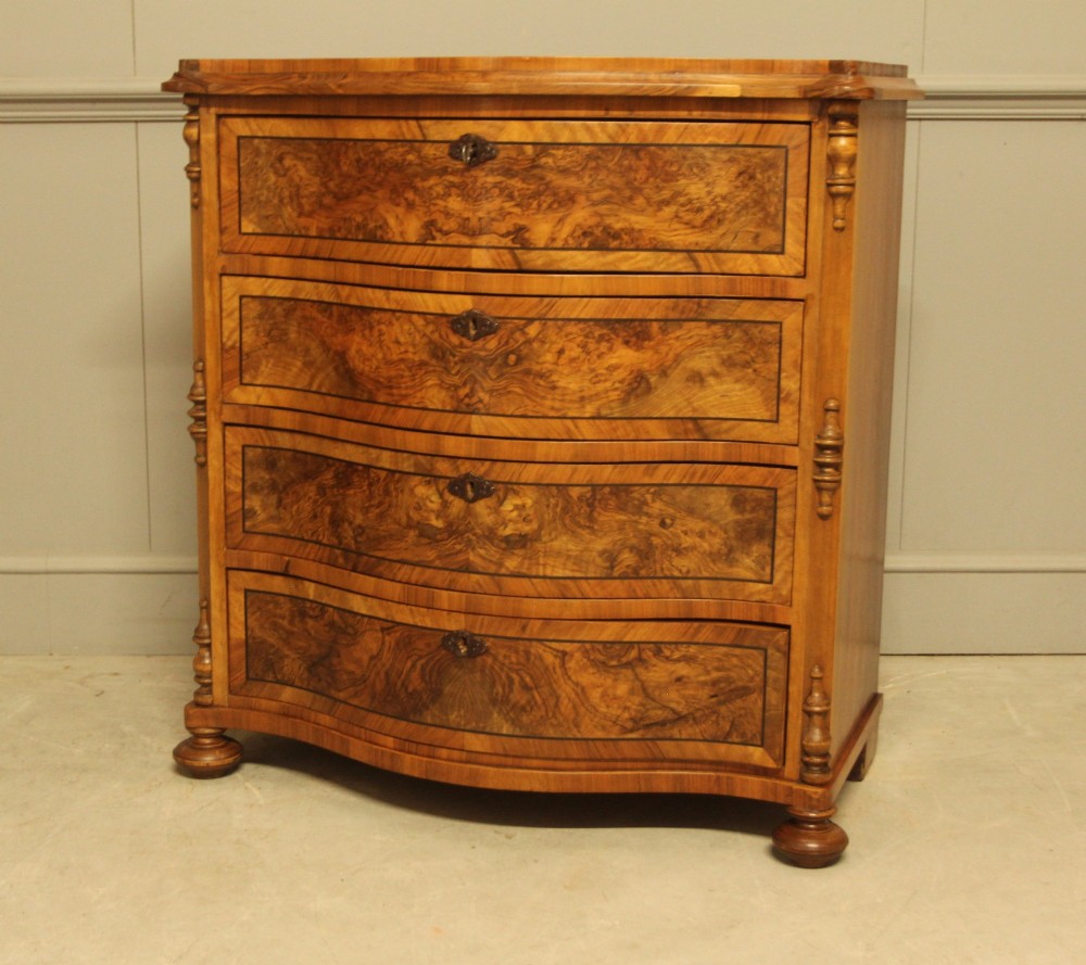 A 19th-century Swedish burr walnut chest featuring four serpentine-front drawers, bookmatched veneers, turned side pilasters, and bun feet. View III