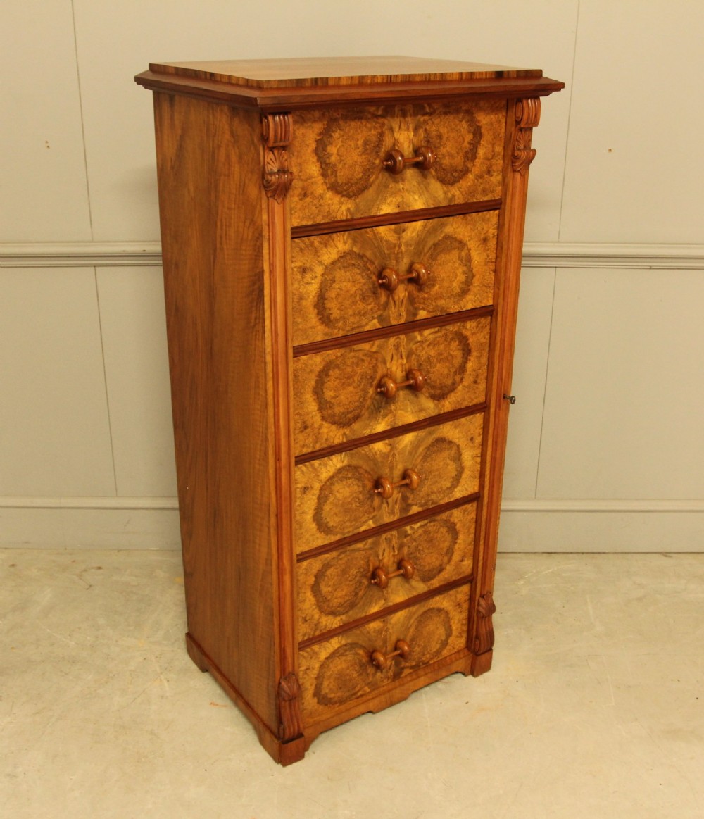 A tall 19th-century Swedish Wellington chest featuring six book-matched burr walnut drawers with turned handles, flanked by carved pilasters. View VIII