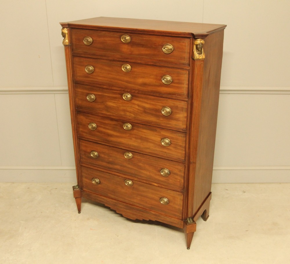 A French 19th-century mahogany tallboy chest of drawers featuring six drawers, brass ring handles, escutcheons, and fluted side pilasters topped with brass busts. View VIII