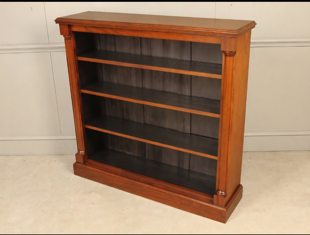A Victorian open mahogany bookcase featuring four shelves flanked by turned pilasters on a solid plinth base. View III