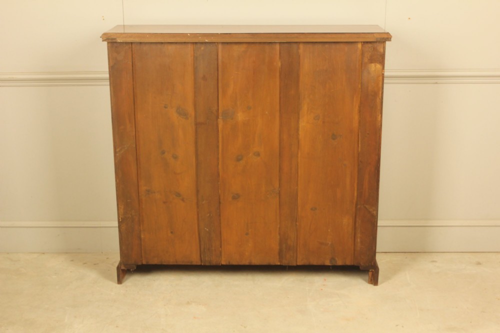 A Victorian open mahogany bookcase featuring four shelves flanked by turned pilasters on a solid plinth base. View IX