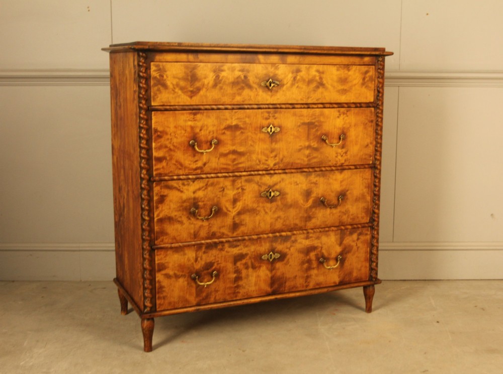 A nineteenth-century Swedish chest of drawers crafted from highly figured flame birch veneer, featuring four full-width drawers with brass drop handles, brass escutcheons, and spiral-twisted side columns. View II
