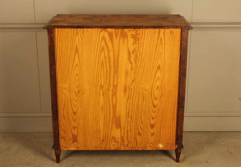 A nineteenth-century Swedish chest of drawers crafted from highly figured flame birch veneer, featuring four full-width drawers with brass drop handles, brass escutcheons, and spiral-twisted side columns. View X