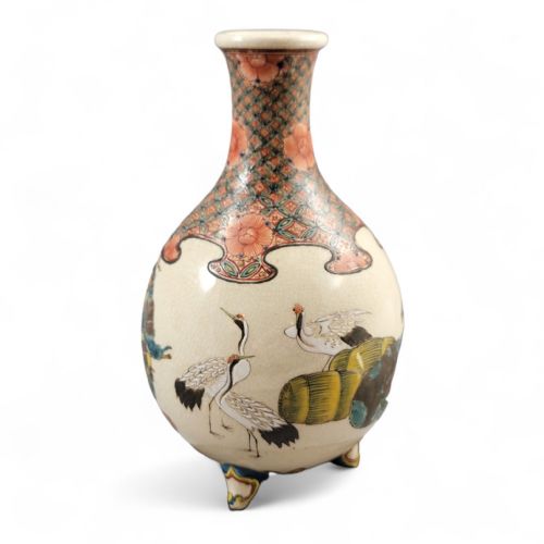 fig 1. A Japanese Meiji period Kyoto Satsuma earthenware miniature vase resting on three small feet, featuring hand-painted figures of the Seven Gods of Good Fortune set against a cream crackle glaze background.