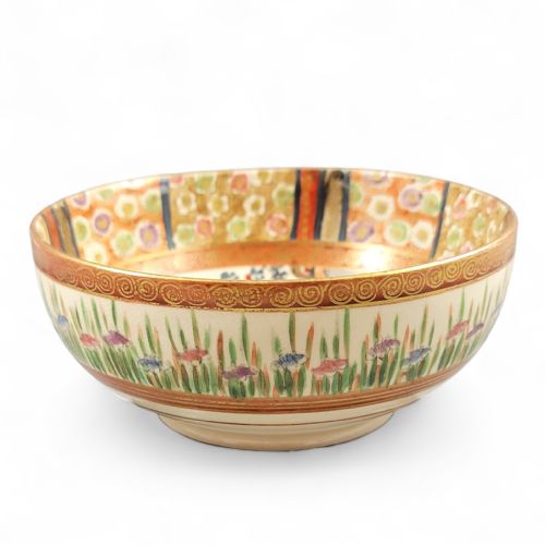 fig 1. A round Japanese Kyoto Satsuma earthenware bowl featuring hand-painted figures, floral borders, and gold gilding over a cream crackle glaze.