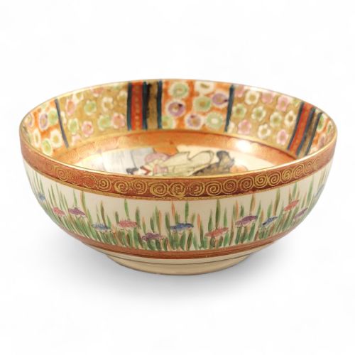 fig 2. A round Japanese Kyoto Satsuma earthenware bowl featuring hand-painted figures, floral borders, and gold gilding over a cream crackle glaze.