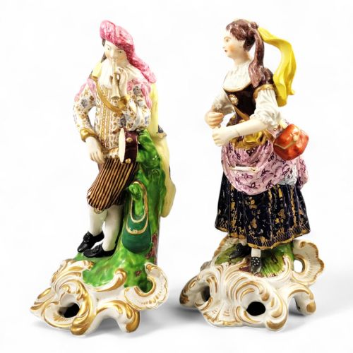 fig 1. A pair of 19th-century Bloor Derby porcelain figurines depicting a male and female musician in colourful costume on gilded rocaille bases.