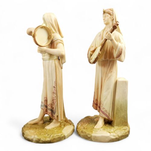 fig 4. A pair of Victorian Royal Worcester porcelain figures depicting Egyptian musicians with detailed draped robes and musical instruments on naturalistic bases.