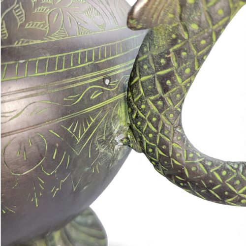 fig 3. An antique dark bronze Indian aftaba ewer featuring an engraved bulbous body, a creature-shaped spout, a fluted base, and a Makara handle.
