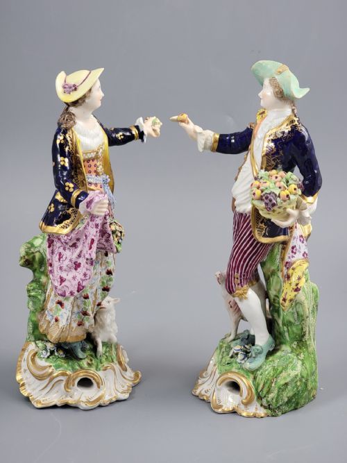 fig 1. A pair of 19th-century Bloor Derby porcelain figurines depicting a shepherdess with a lamb and a shepherd with a dog, painted in multi-coloured enamels with gilded Rococo scroll bases.